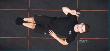 Professional jumper performs an aerial jump on a BERG Pro Bouncer trampoline Sports, top view, banner