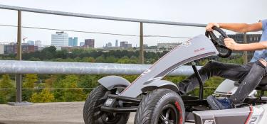 Boy racing on a BERG XL go-kart with sporty race design – banner