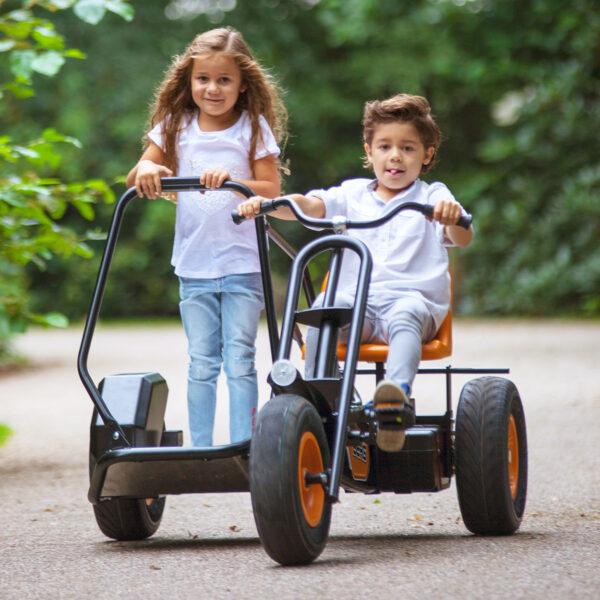 Children playing on BERG Chopper tricycle with robust frame and stable design