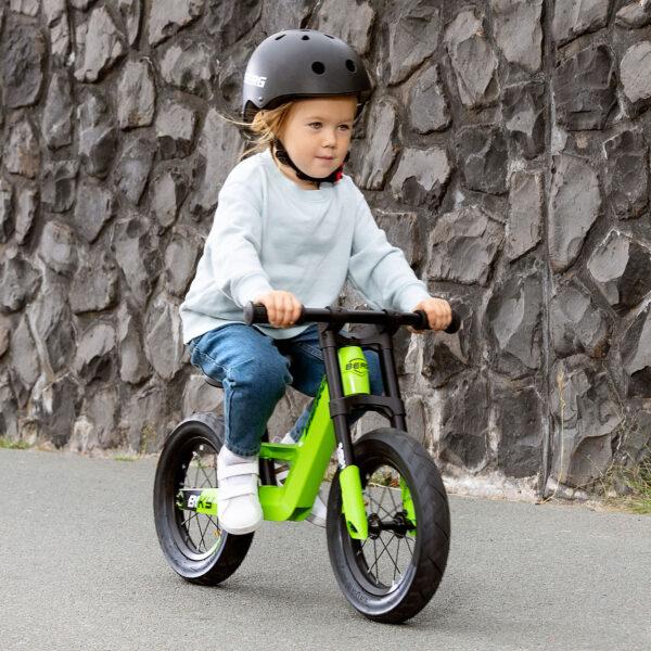 Child riding BERG Biky balance bike, lightweight and maneuverable design