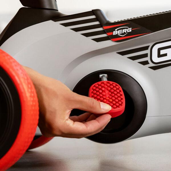 Hand unfolds the pedals on the BERG GO² ride-on car