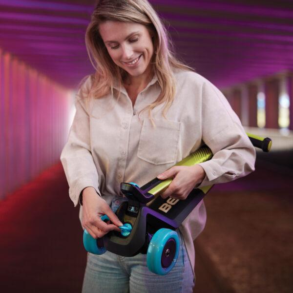 Woman easily folds the BERG Nexo kids’ scooter with smart click system