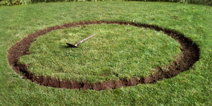 Dug-out circle in the grass as preparation for installing a BERG inground trampoline