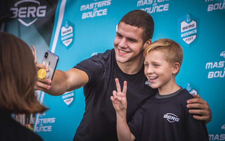 Moment fan BERG Masters of Bounce : enfant prend un selfie avec un athlète de trampoline