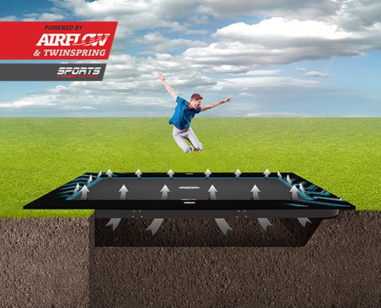 Boy jumping on a BERG Ultim FlatGround rectangular trampoline Sports with AirFlow and TwinSpring