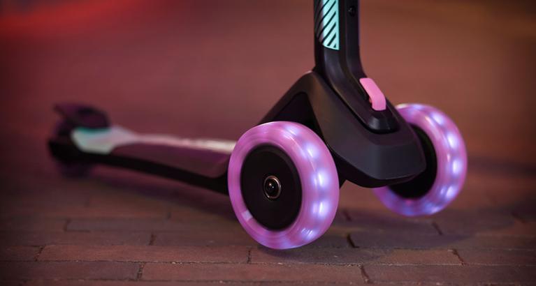 Close-up of a BERG Nexo scooter with illuminated wheels for a stylish effect