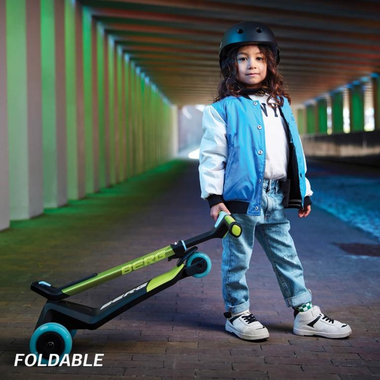 Child with a folded BERG Nexo scooter in a tunnel, perfect for travel