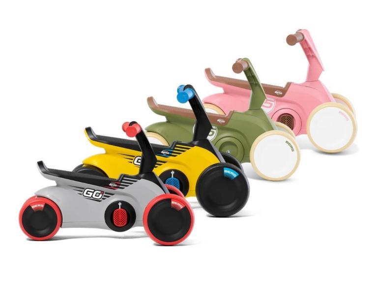 Four BERG GO ride-on cars in different colors and designs