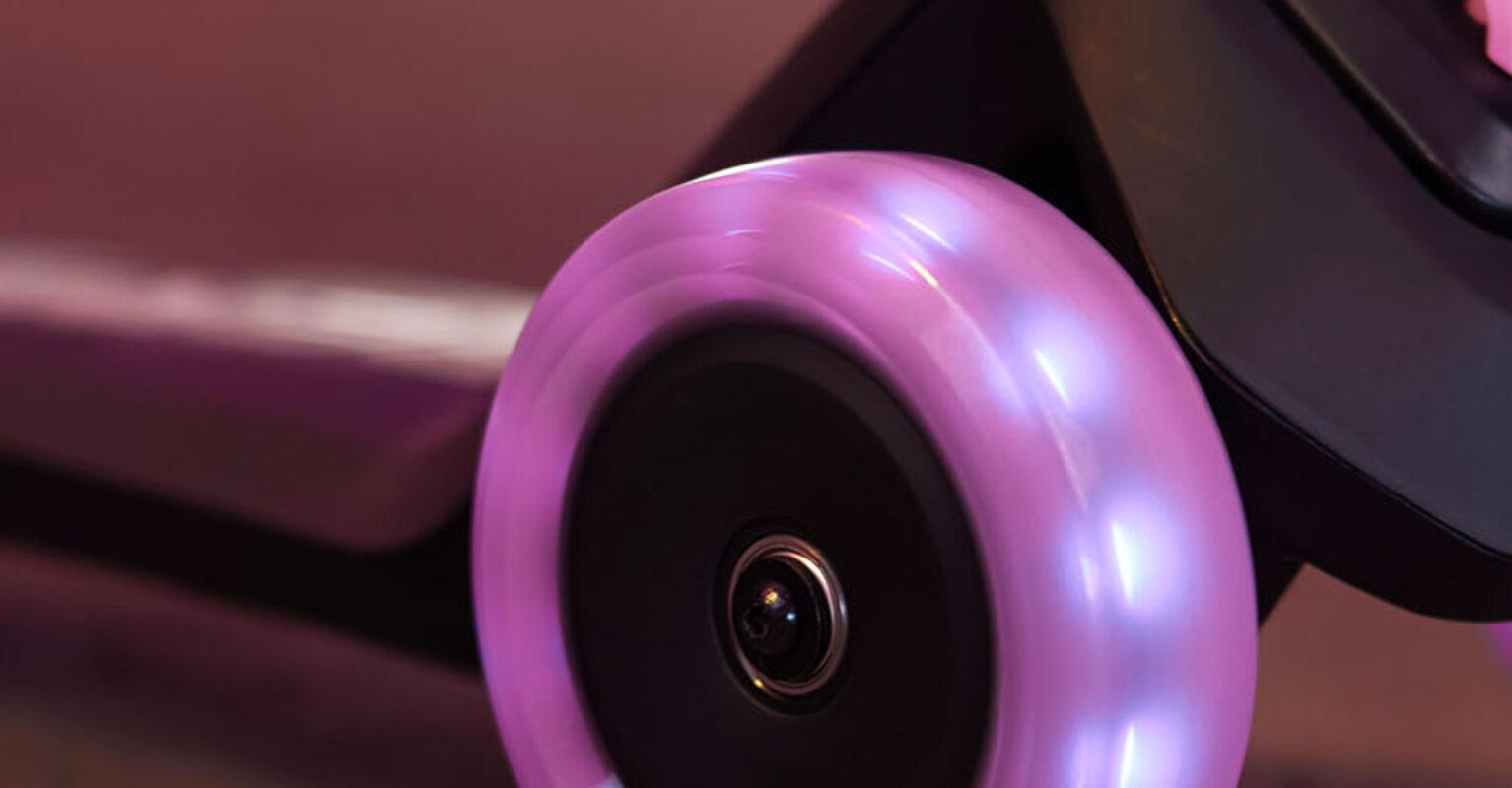 Banner with close-up of a BERG Nexo scooter with illuminated wheels