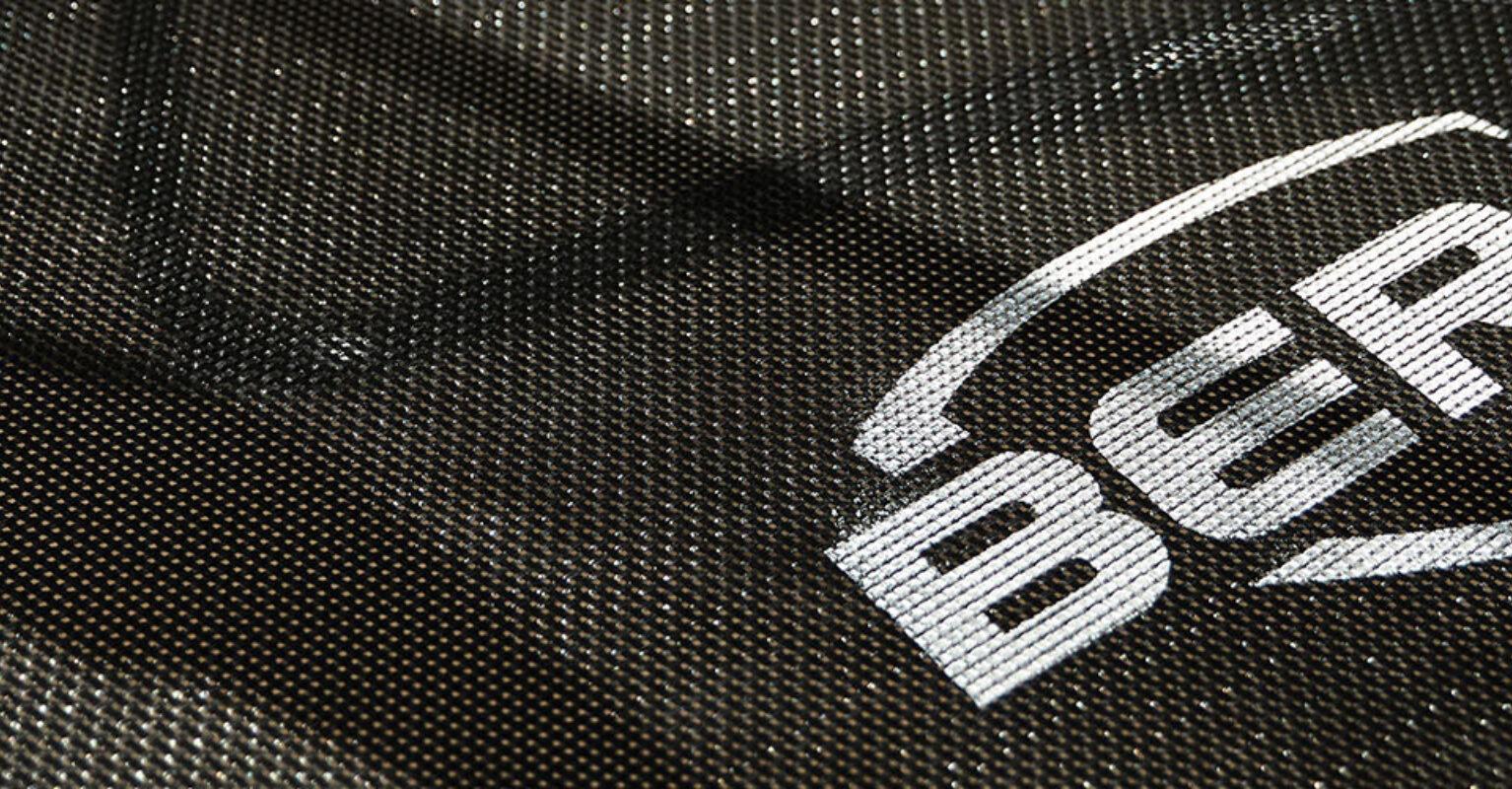 Close-up of the BERG trampoline jumping mat with logo and shadow